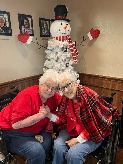 Mom and Lela, hands clasped, heads together