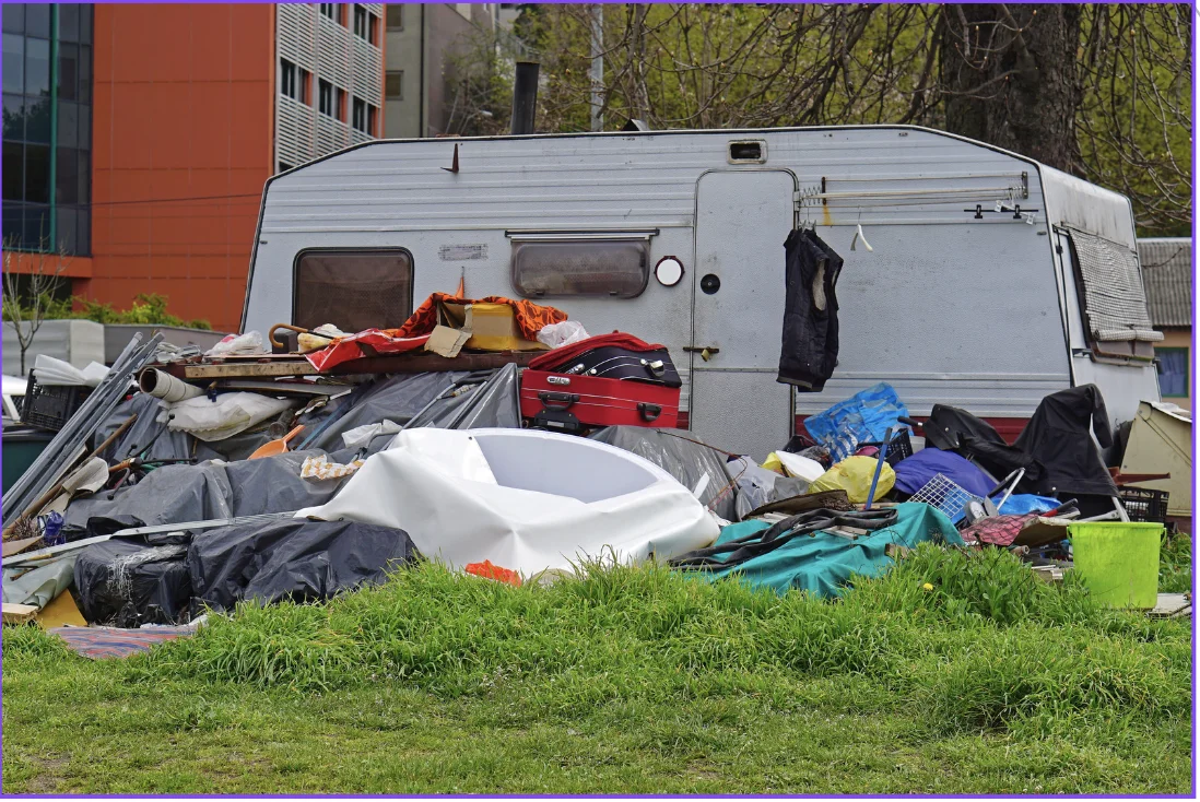 Camper surrounded by hoarded junk
