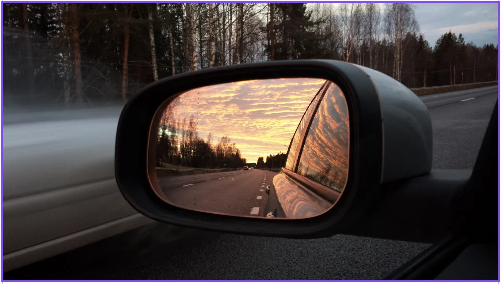 Sunset reflected in driver's side mirror